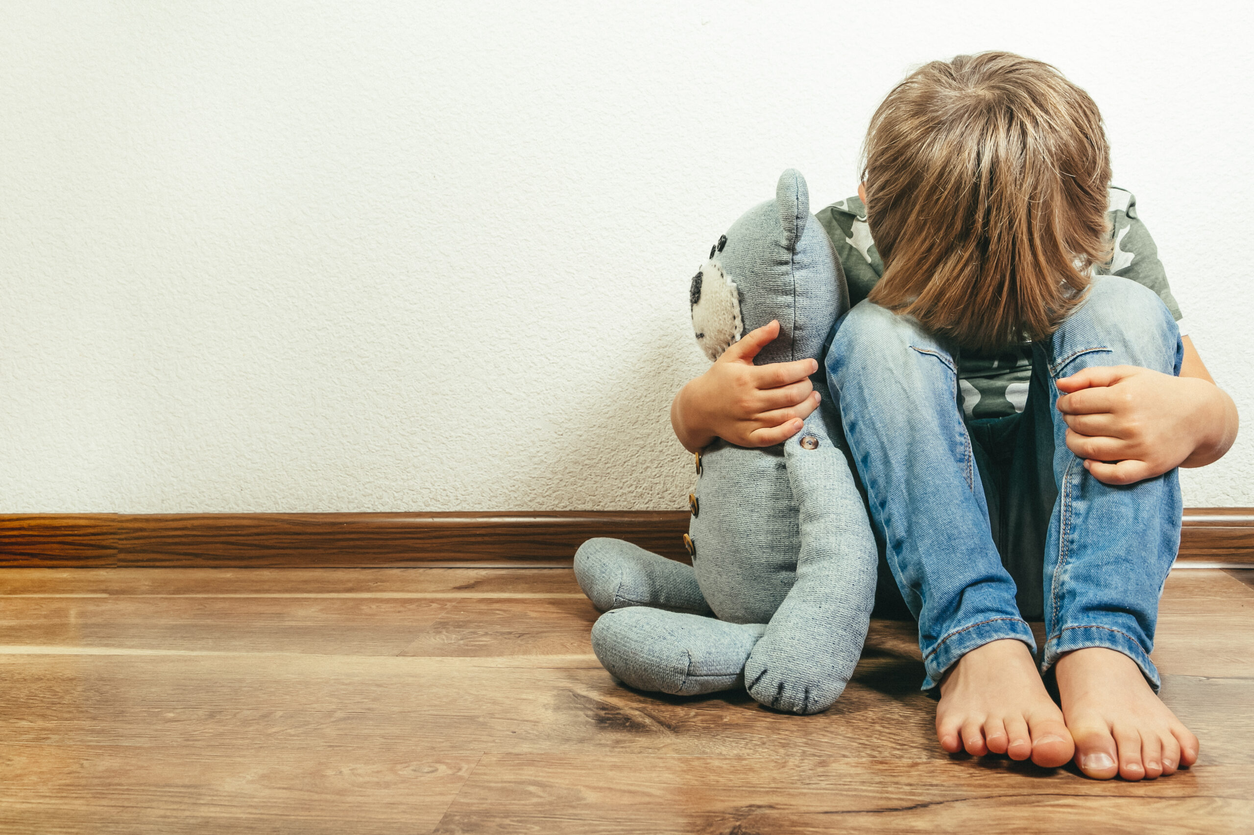Behavioral Cents Logo | Child alone holding teddy bear AdobeStock 238697359